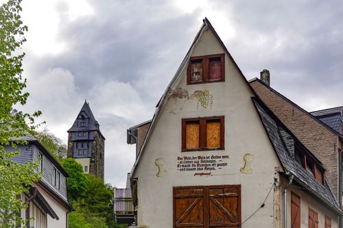 Free Quaint old buildings with a historic tower under a cloudy sky. Stock Photo