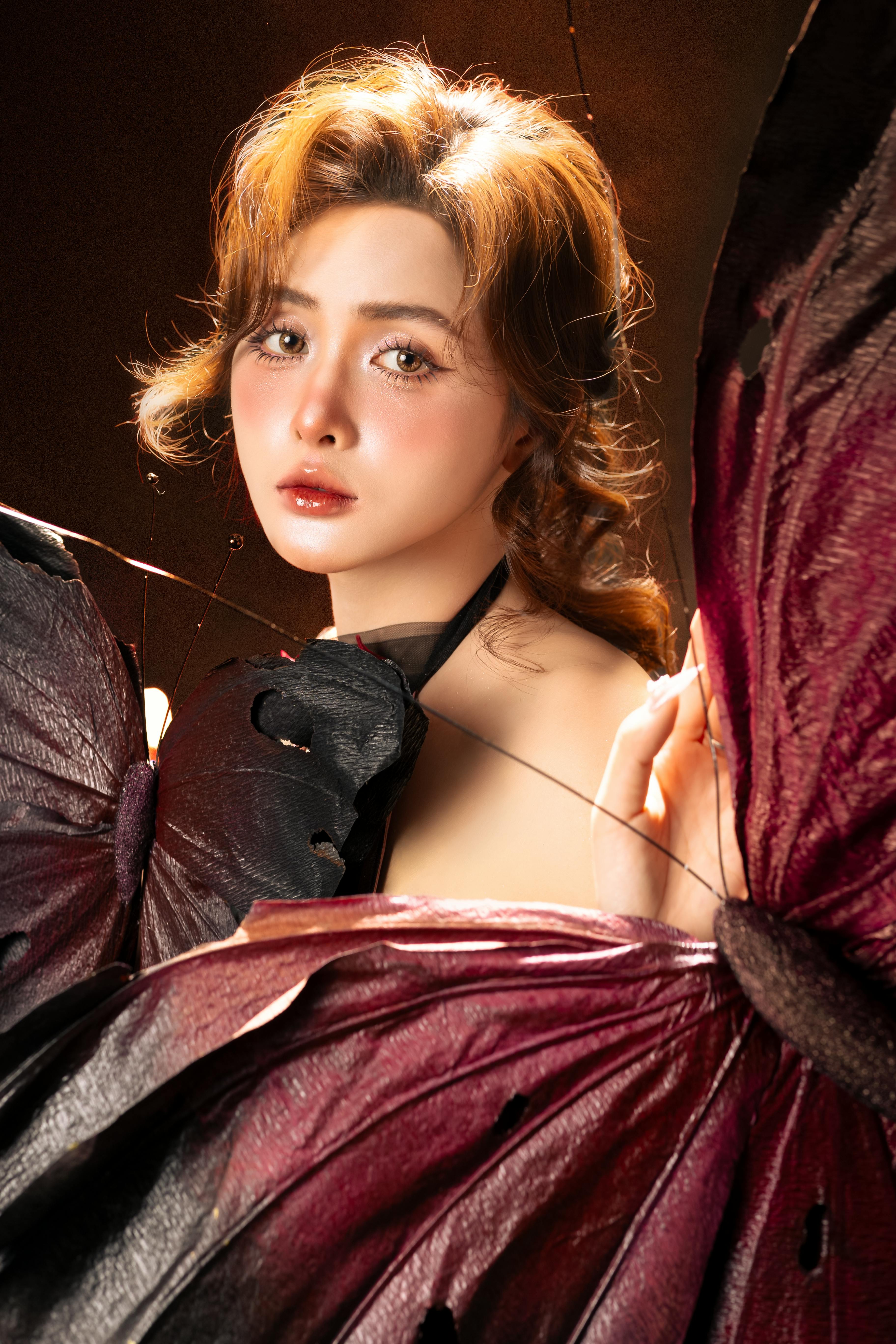 Enchanting portrait of a woman with butterfly wings evoking a fairy-like appearance.