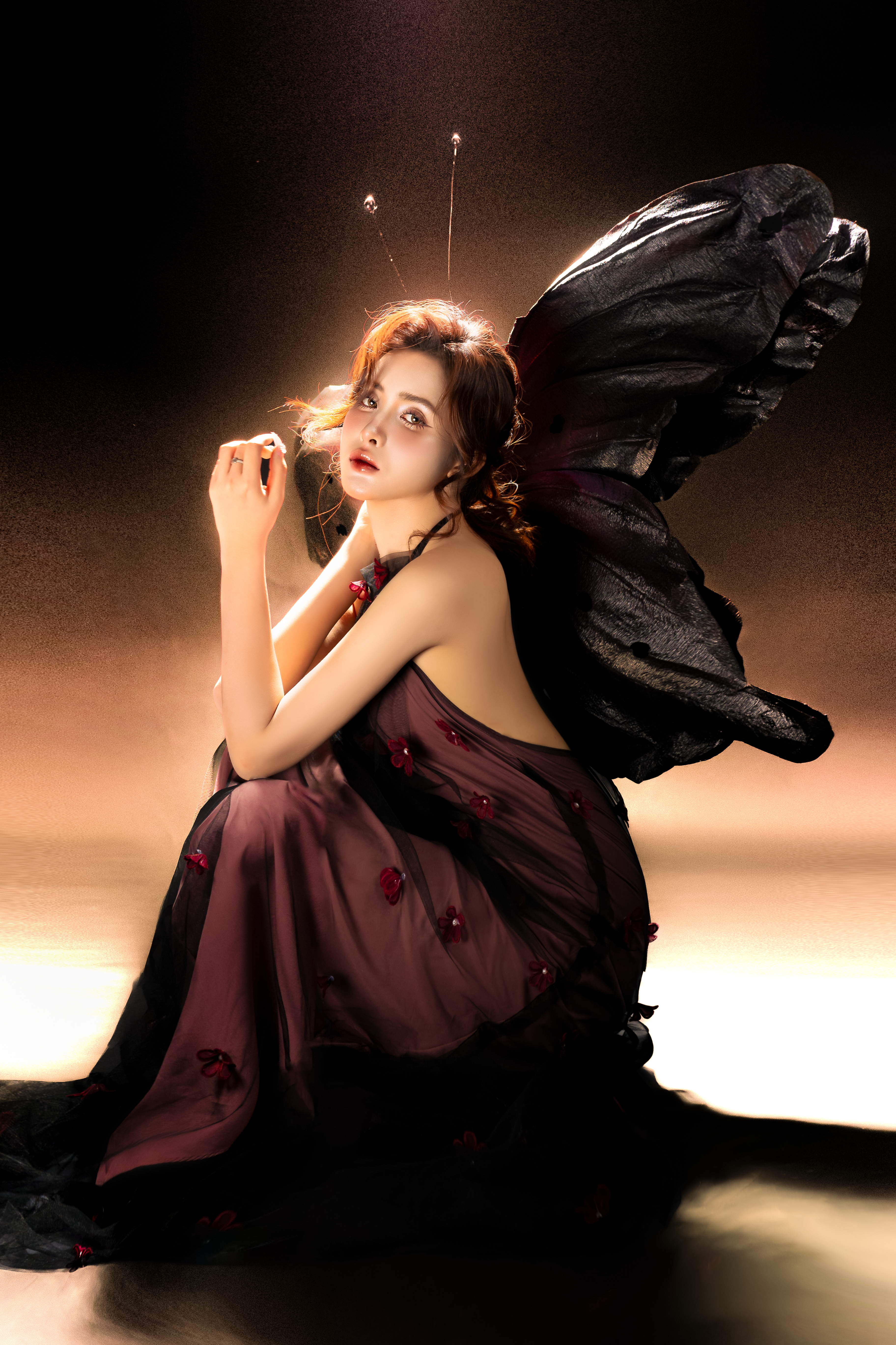 Beautiful woman dressed as a fairy in dramatic lighting, evokes fantasy and magic.