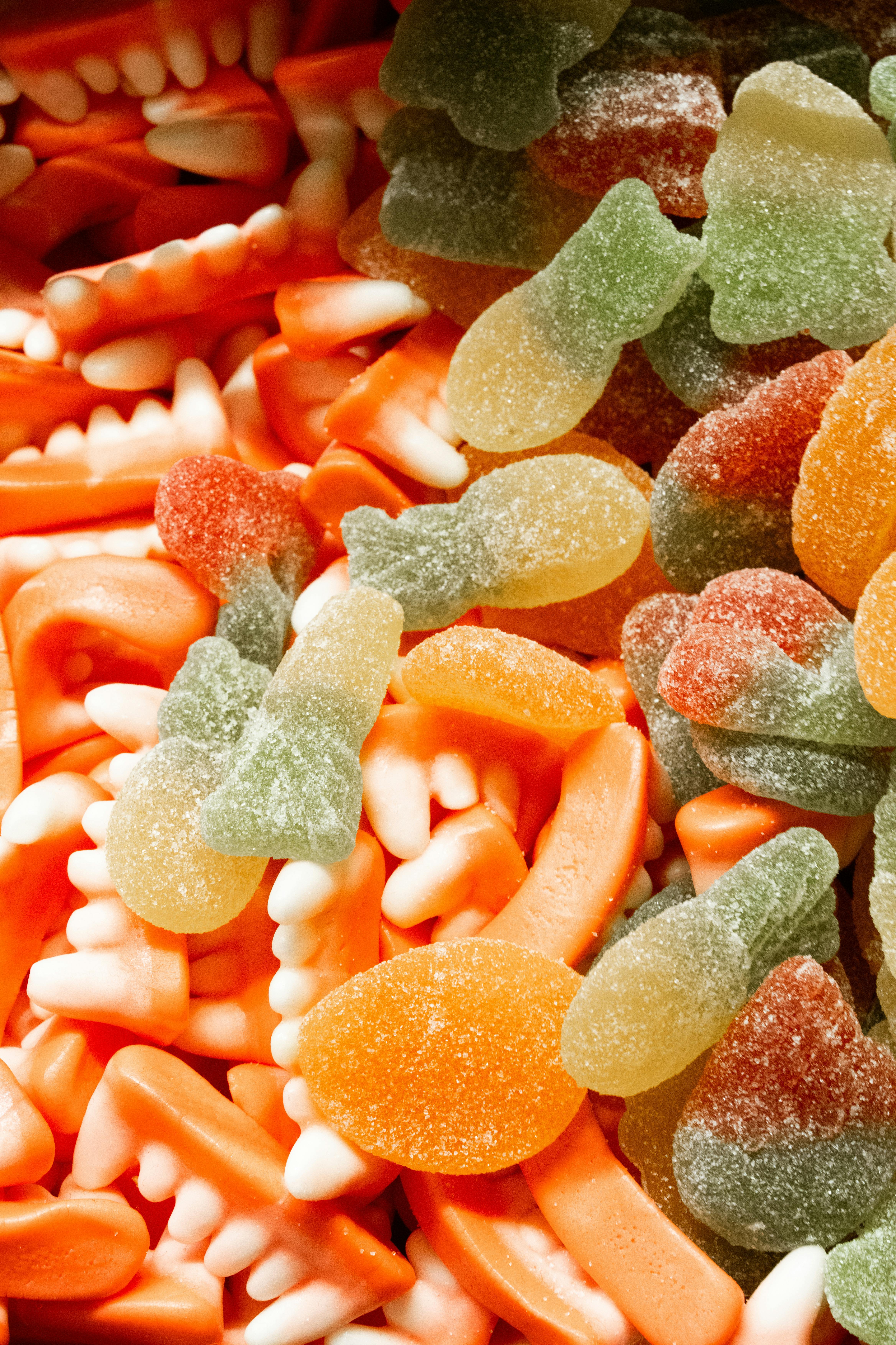 Vibrant mix of gummy candies including teeth shapes and fish designs.