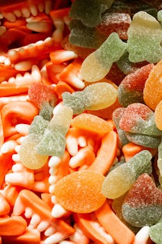 Vibrant mix of gummy candies including teeth shapes and fish designs.