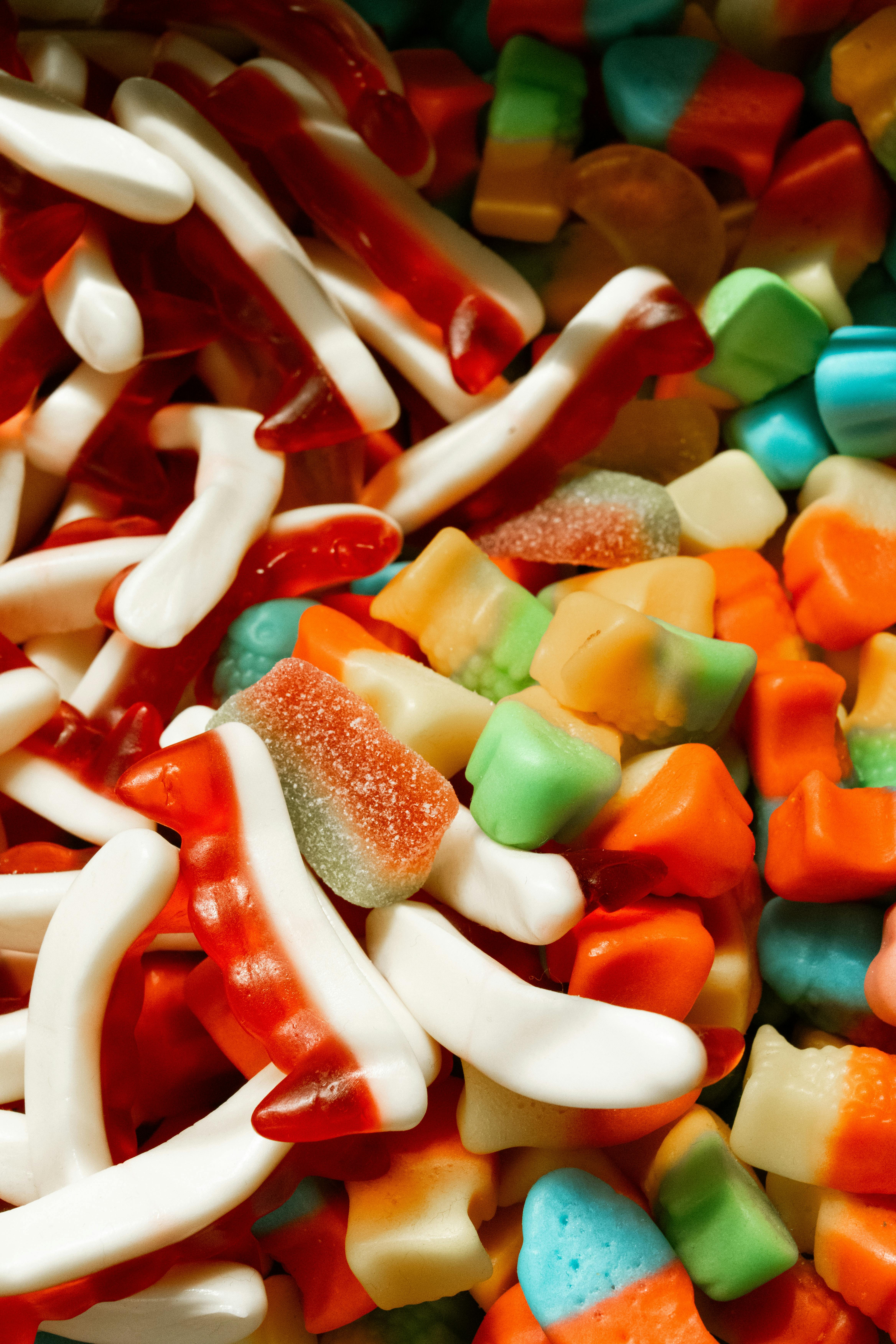 Vibrant assortment of various gummy candies in mixed shapes and colors.