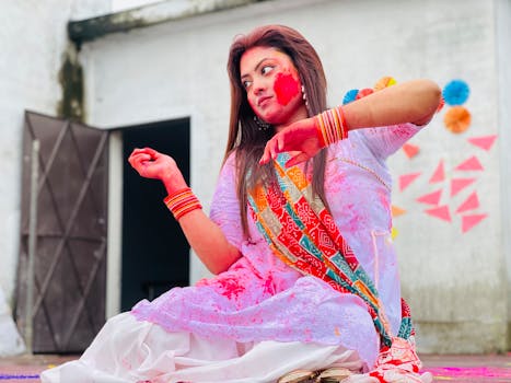 Colorful Holi celebration featuring a woman with vibrant face paint in Bangladesh.