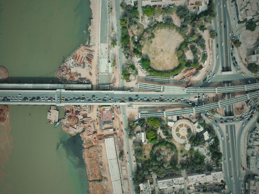 Aerial view of a busy bridge and cityscape in Baghdad, Iraq.