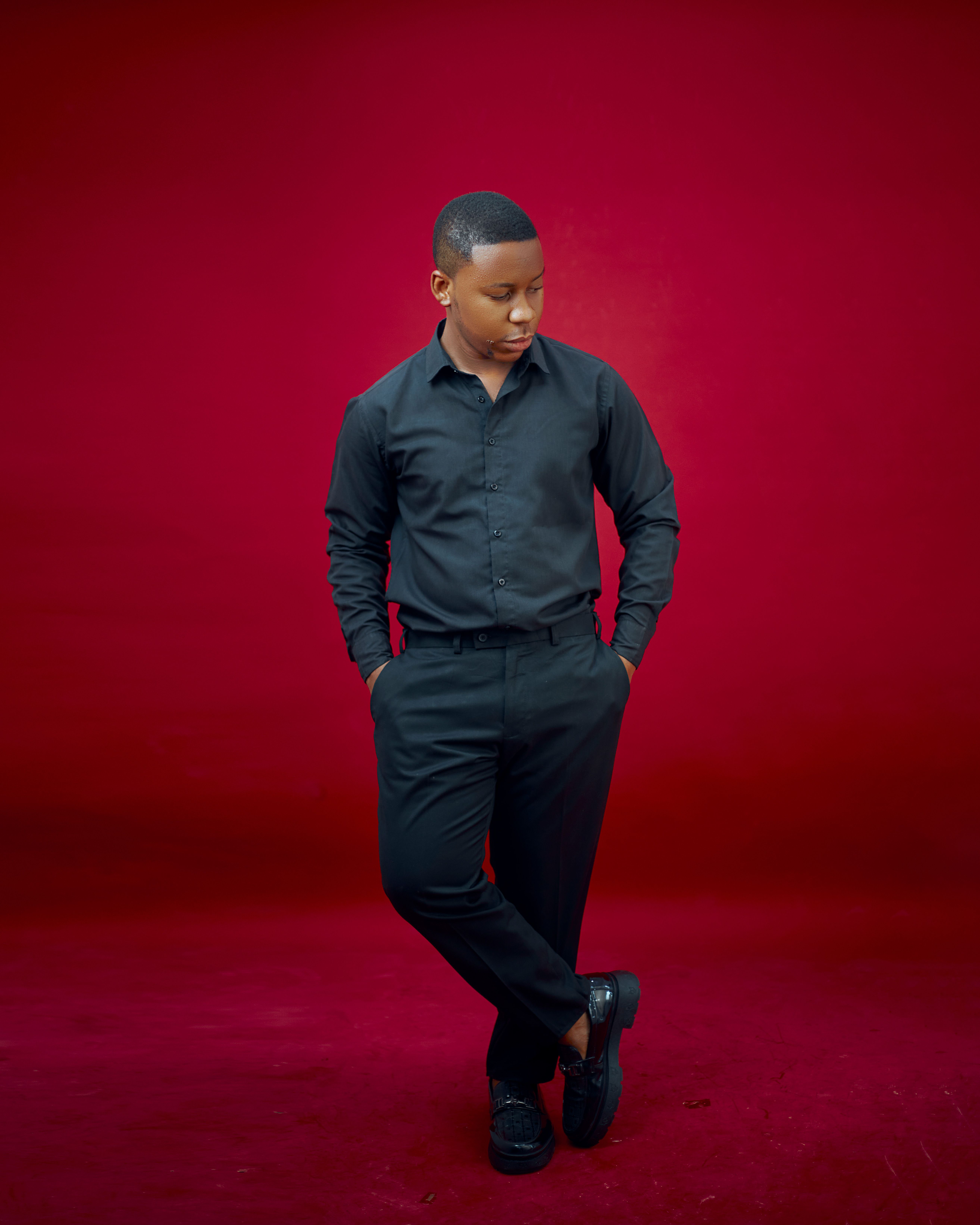 Stylish Young Man Posing Against Red Background · Free Stock Photo