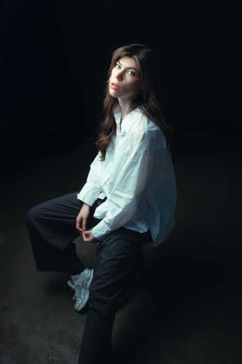 Free Studio portrait of a young woman in casual attire with a contemplative gaze. Stock Photo