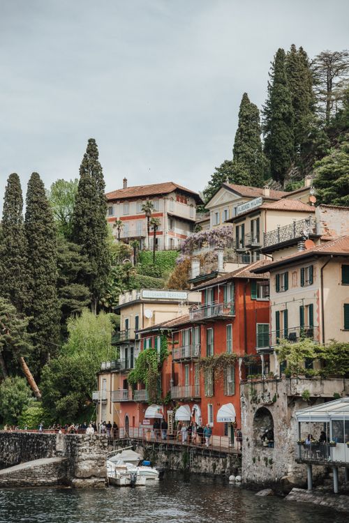 Free Picturesque view of colorful historic houses along Lake Como's waterfront in Lombardy, Italy. Stock Photo