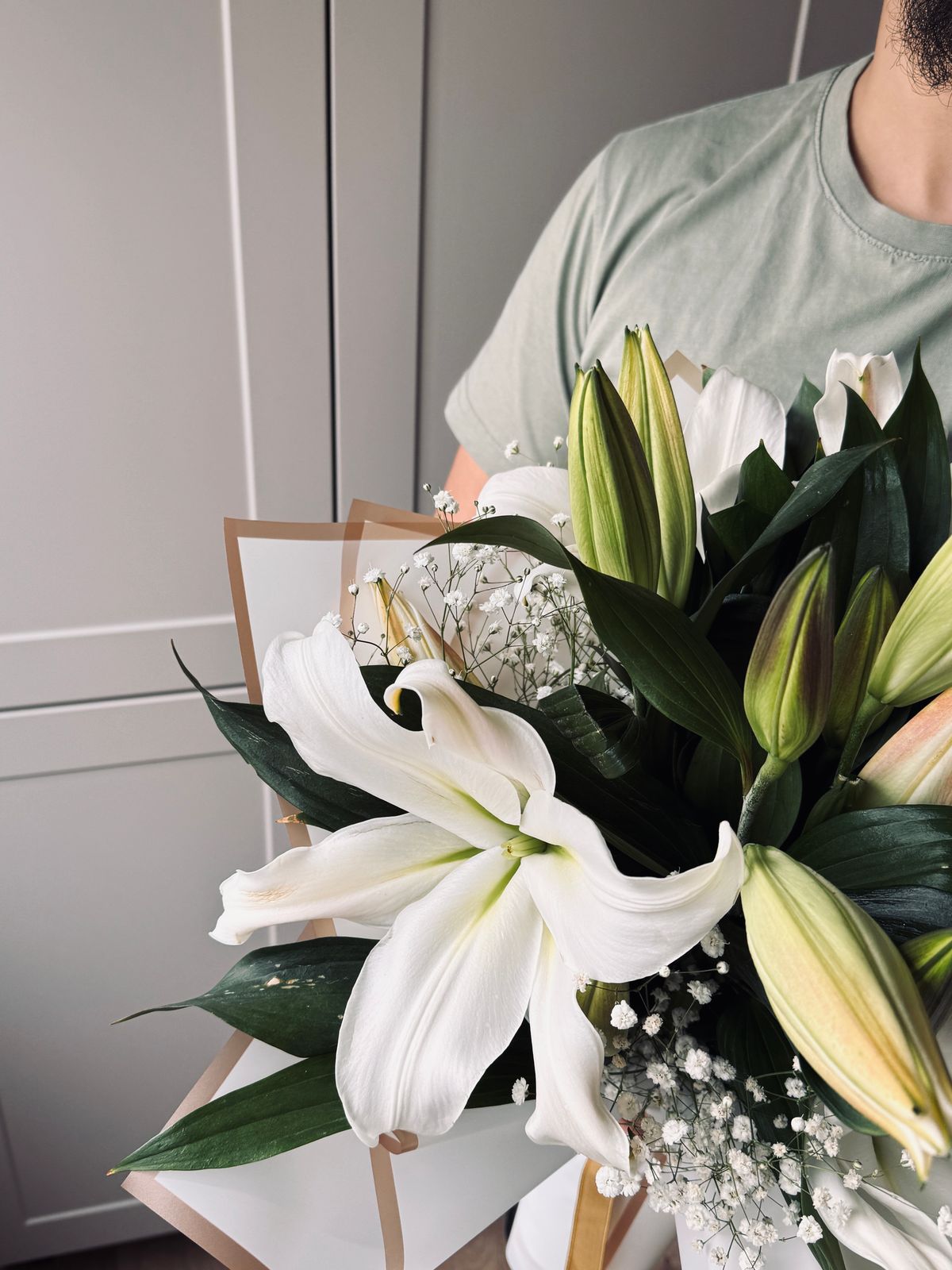 Elegant bouquet of fresh white lilies with lush greenery