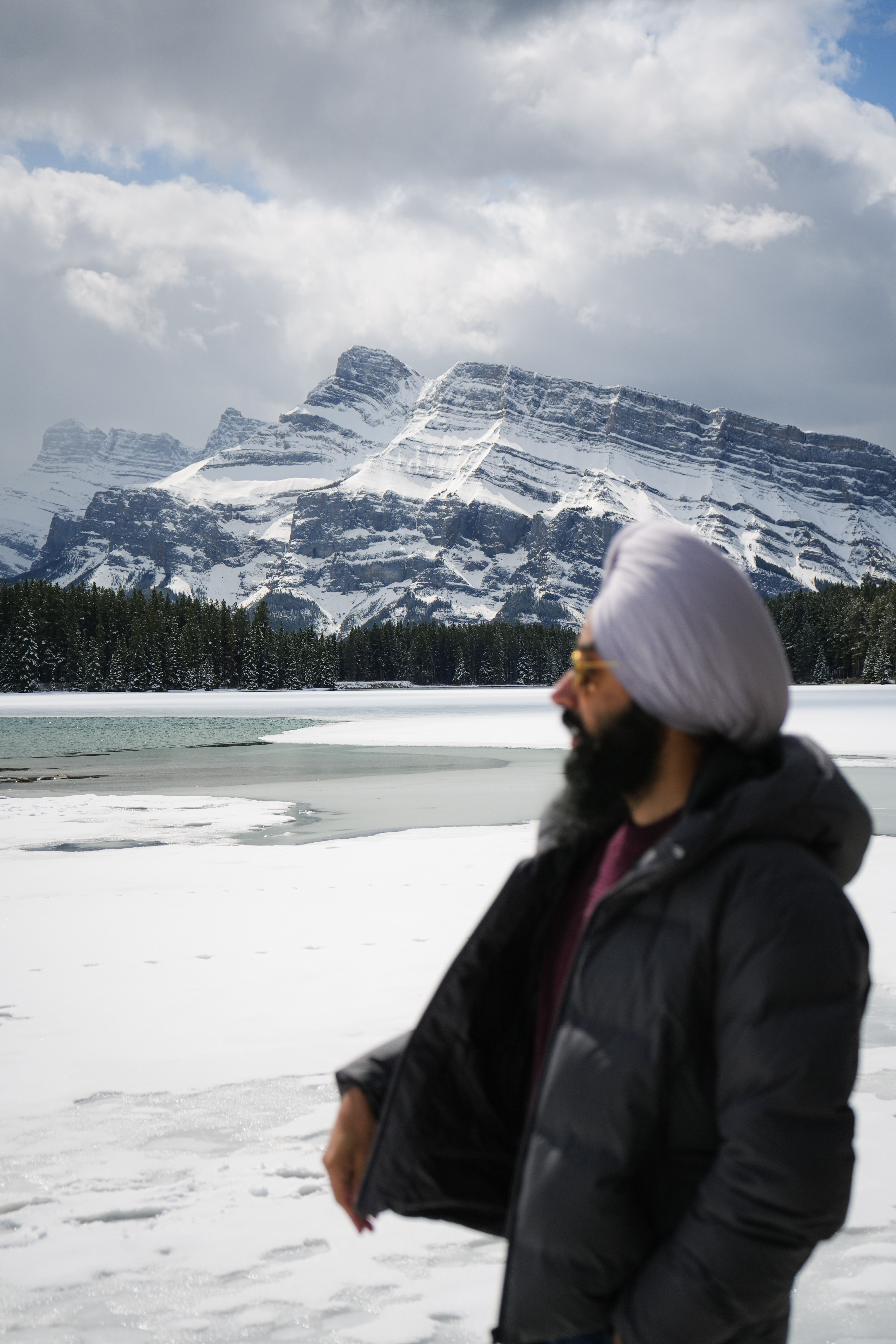Explore the stunning winter landscape of Banff National Park with a person enjoying the snowy scenery.