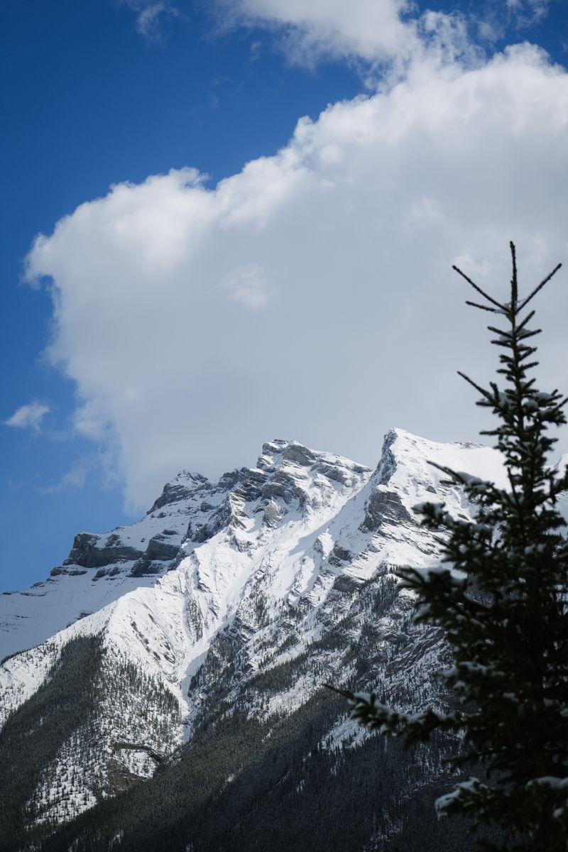 Stunning view of snow-covered mountain peaks with a clear blue sky, perfect for winter landscape enthusiasts.