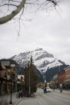 Charming townscape in Banff with a breathtaking snow-capped mountain backdrop, perfect for travel and nature enthusiasts.