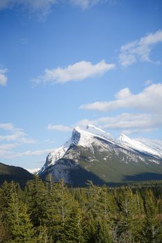 Beautiful snow-capped mountains under a bright blue sky in Banff National Park.