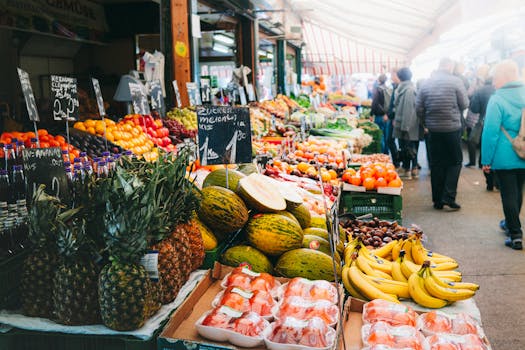 Colorful fruits and vegetables on display at a bustling outdoor market in Vienna, Austria.