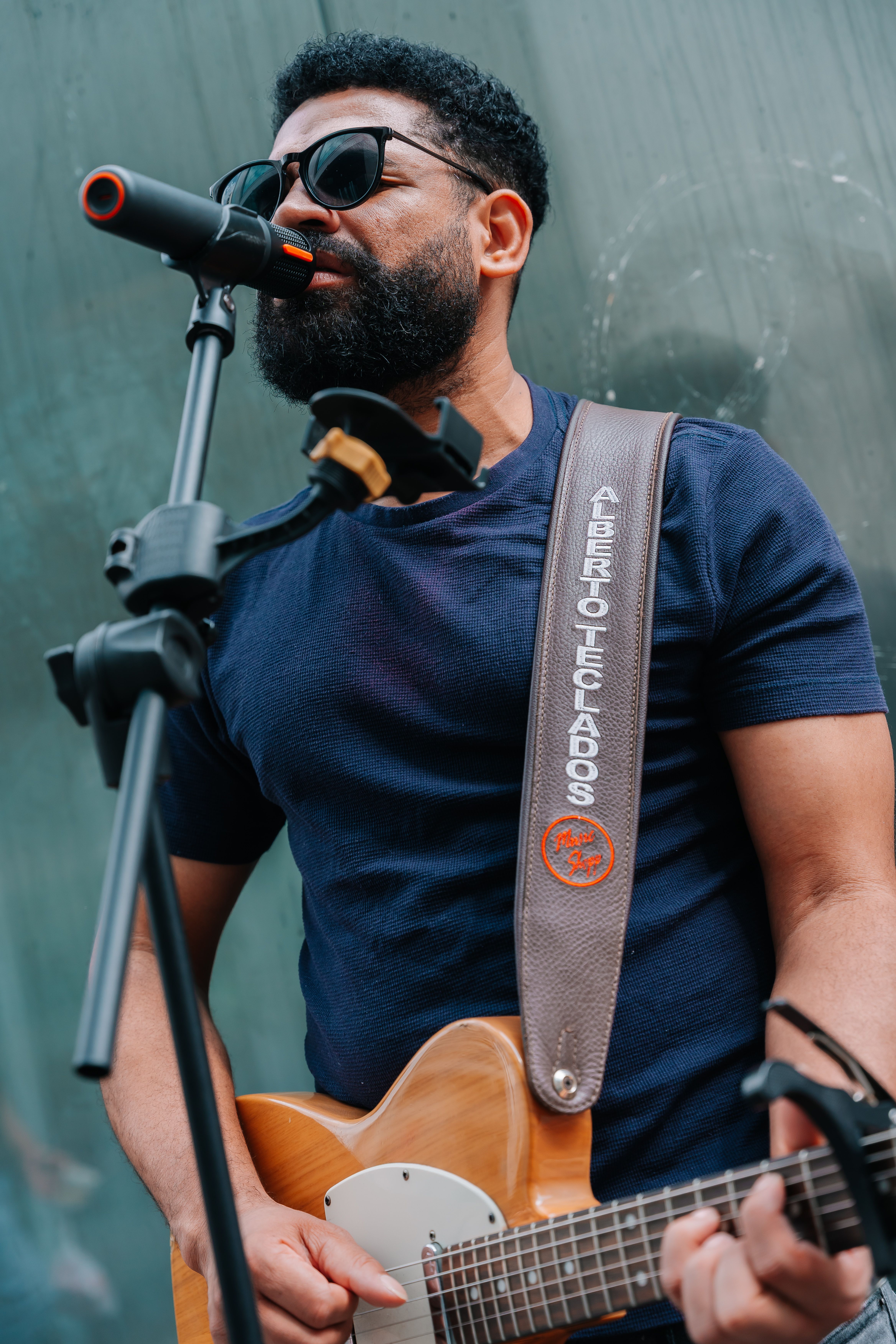 A street performer singing and playing electric guitar