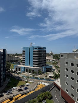 View of Accra's skyline featuring a blue modern skyscraper under a clear sky.