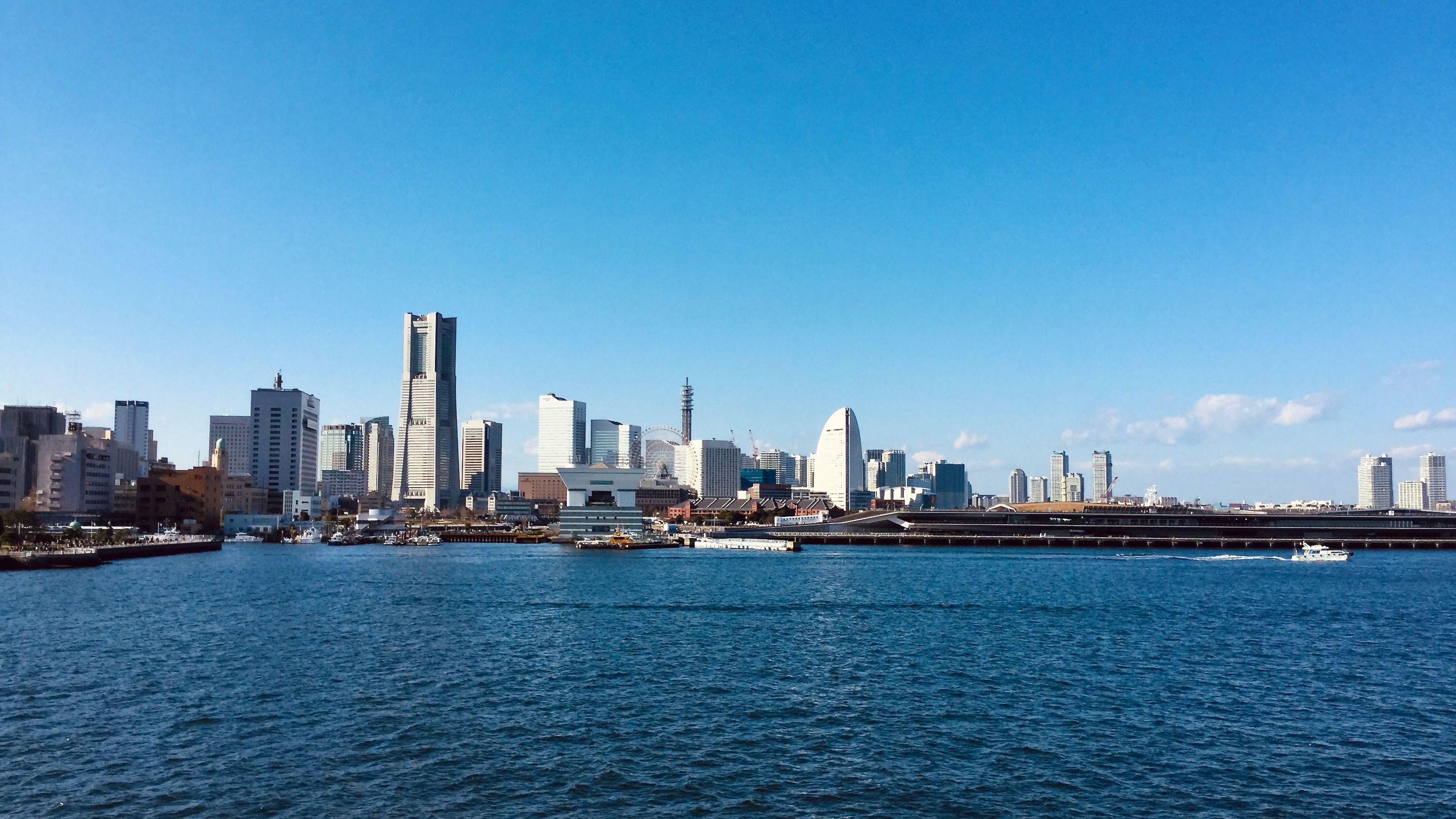 Explore Yokohama's stunning skyline featuring Landmark Tower under a clear blue sky.