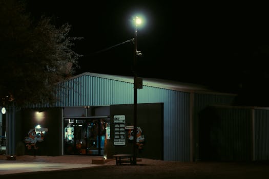 Explore the urban ambiance of a secluded Hermosillo store at night, glowing under streetlights.