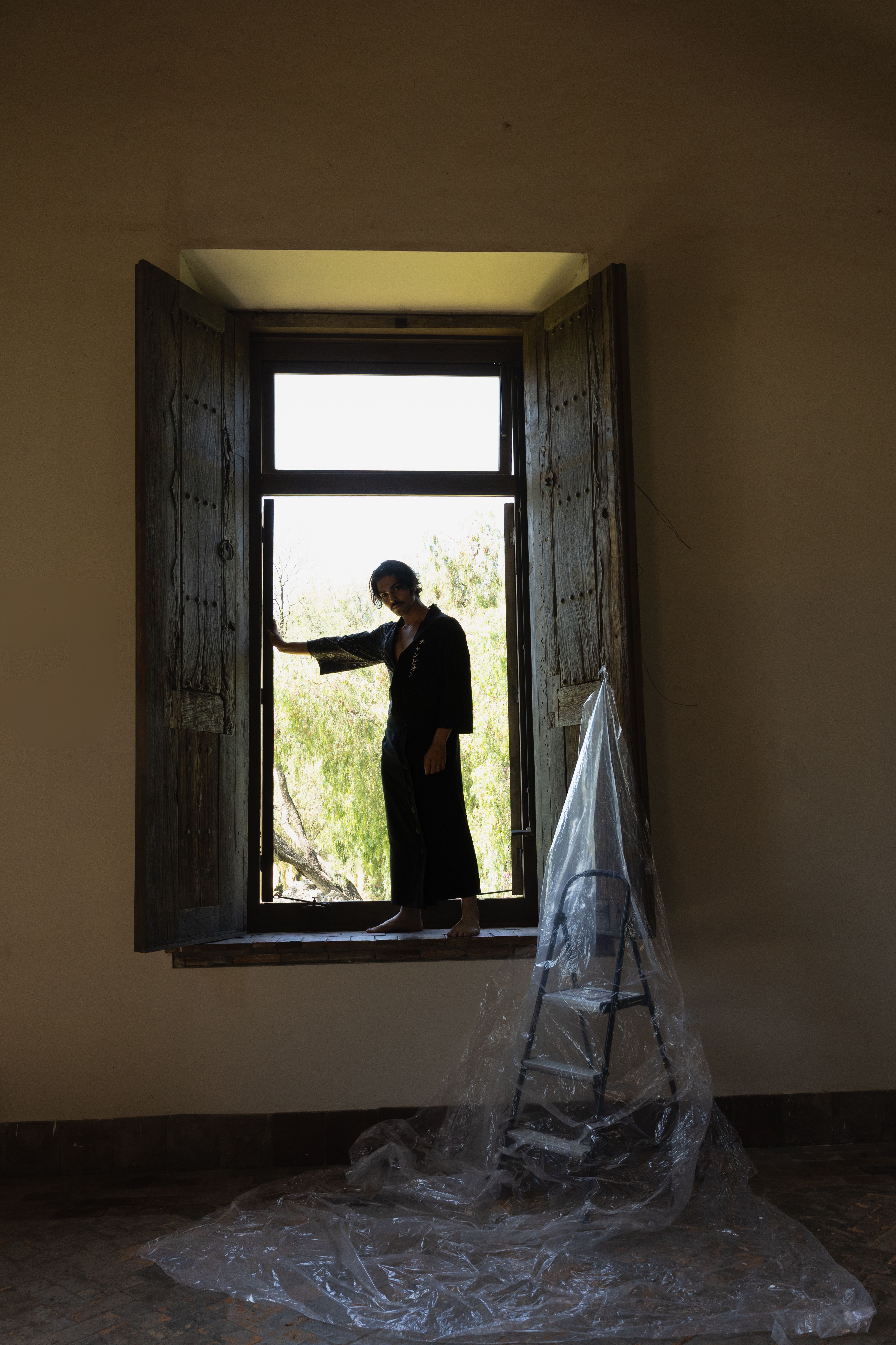 Silhouette of person in open window frame · Free Stock Photo