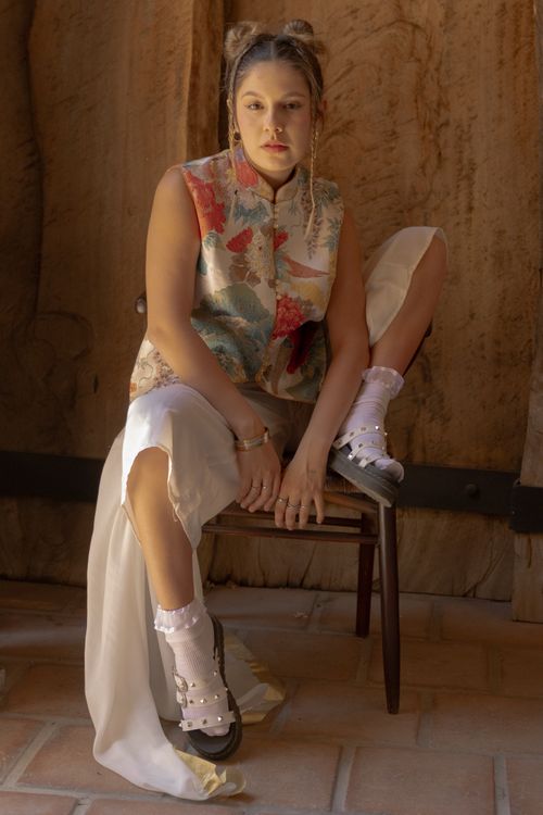 Free Stylish young woman poses in artistic setting, showcasing modern fashion indoors. Stock Photo