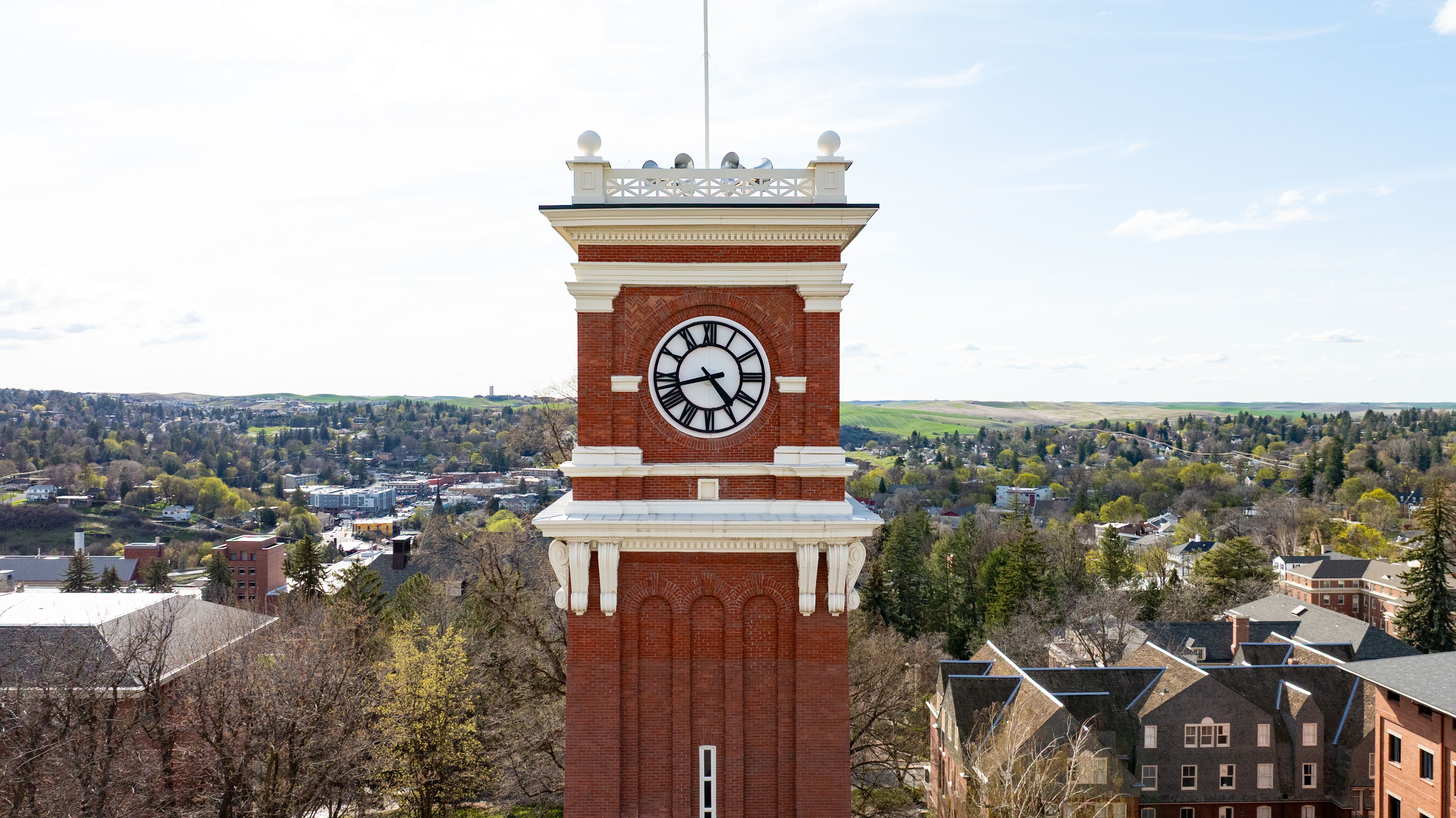Stunning aerial shot of the Washington State University clock tower in Pullman, showcasing scenic surroundings.