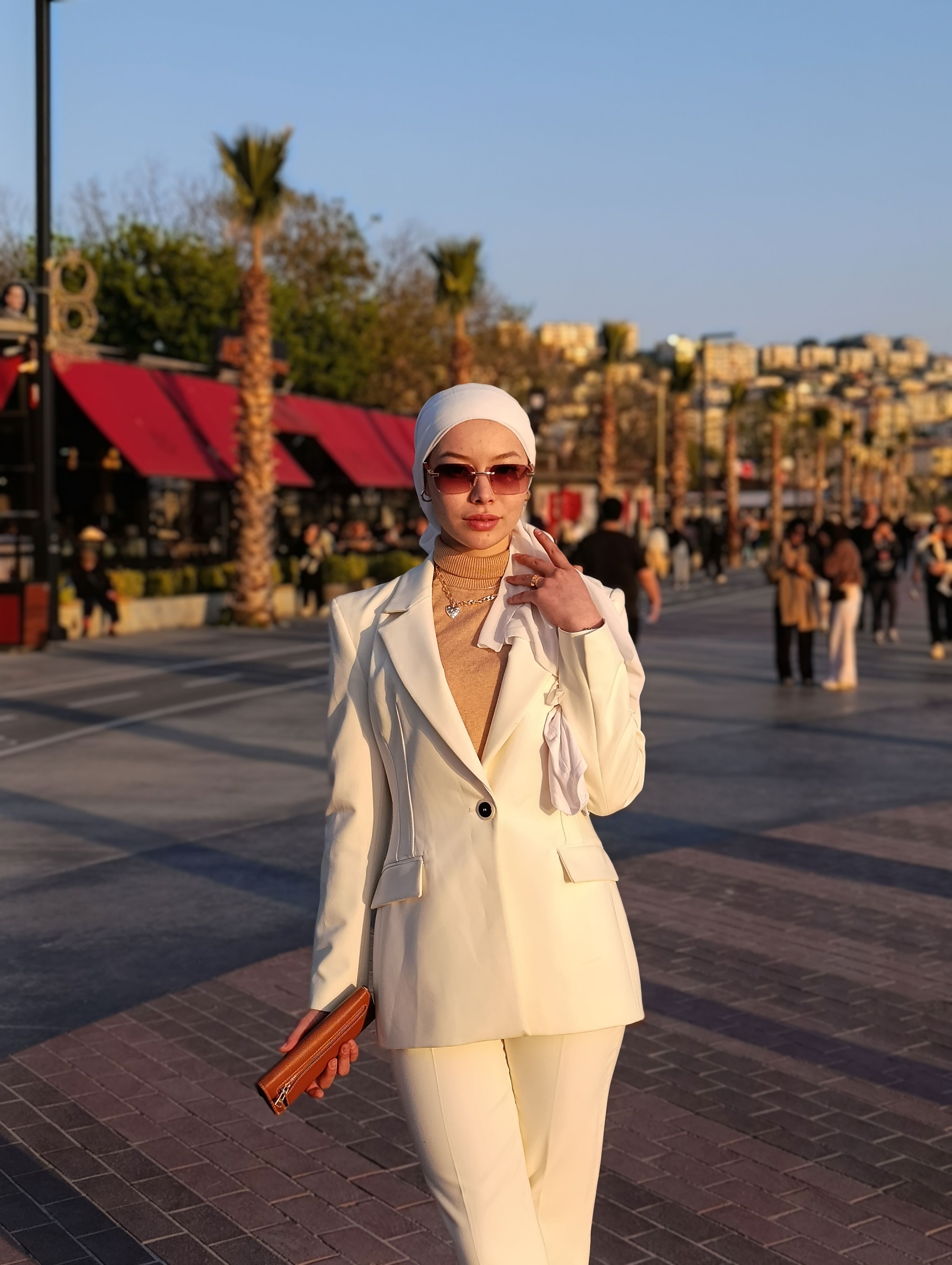 Stylish Woman Walking Down Urban Street in Daylight · Free Stock Photo