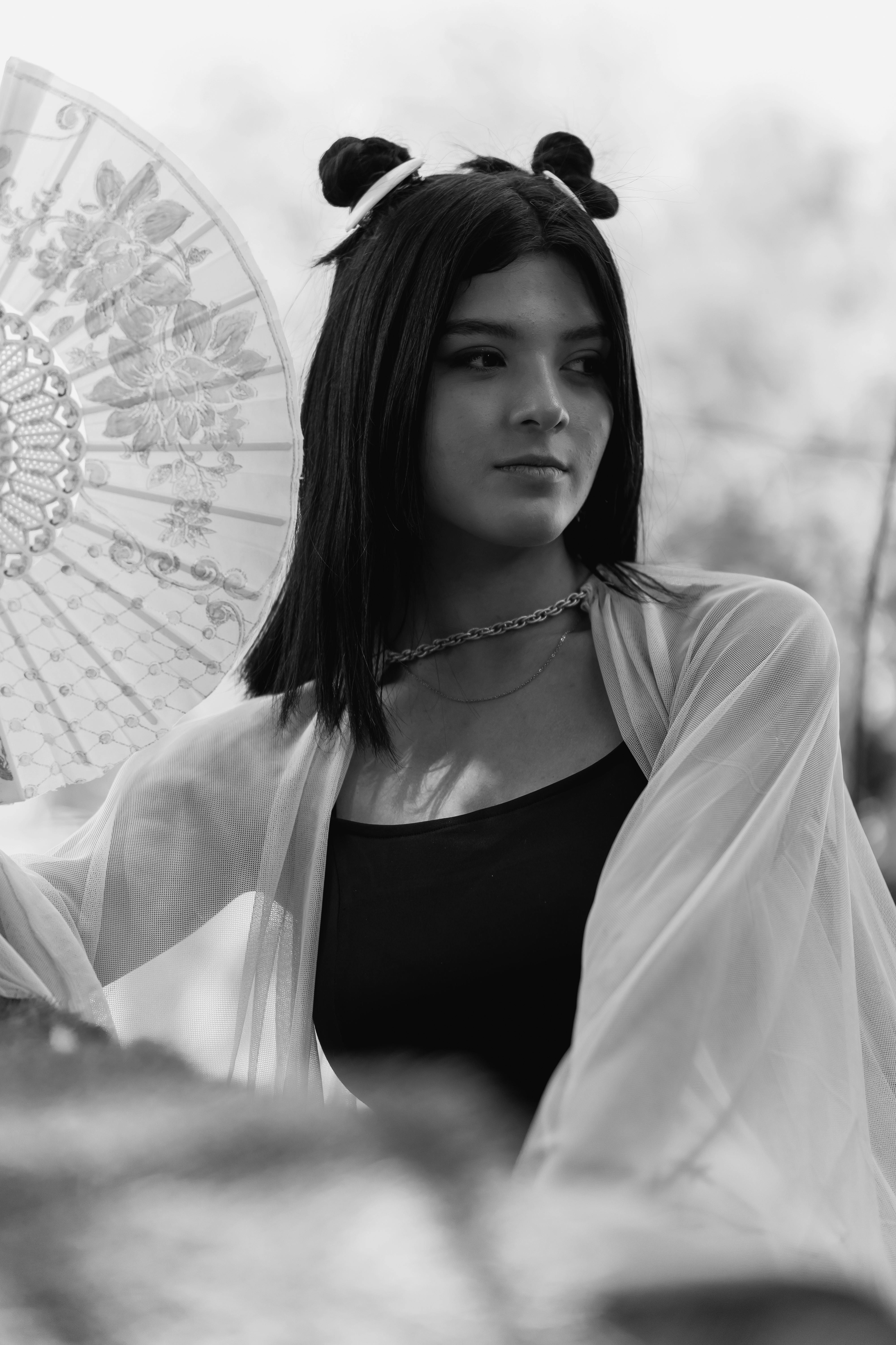 Black and white portrait of a young woman with a Japanese parasol, blending traditional and modern styles.