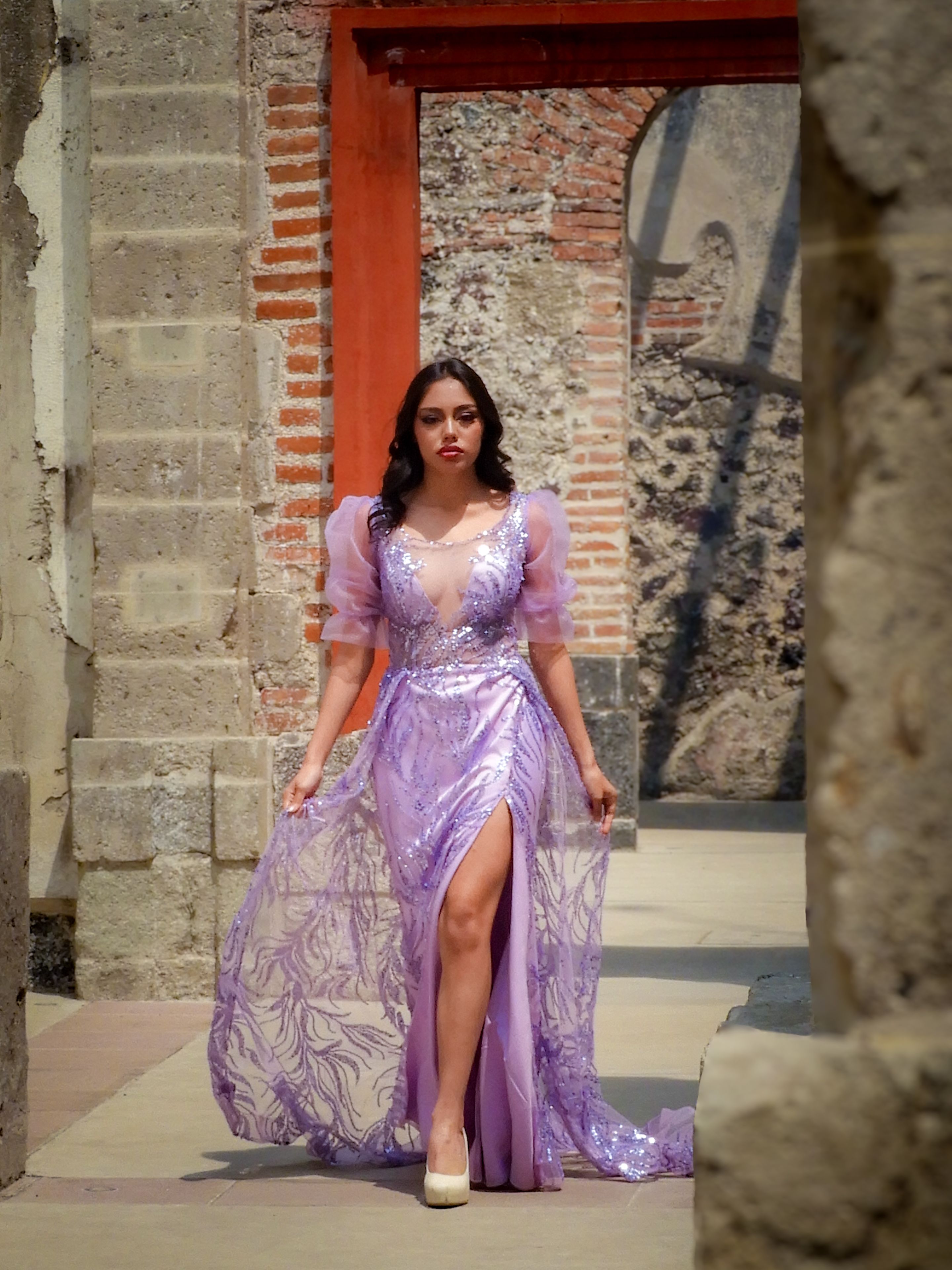 Elegant Woman in Purple Dress Walking in Historic Setting