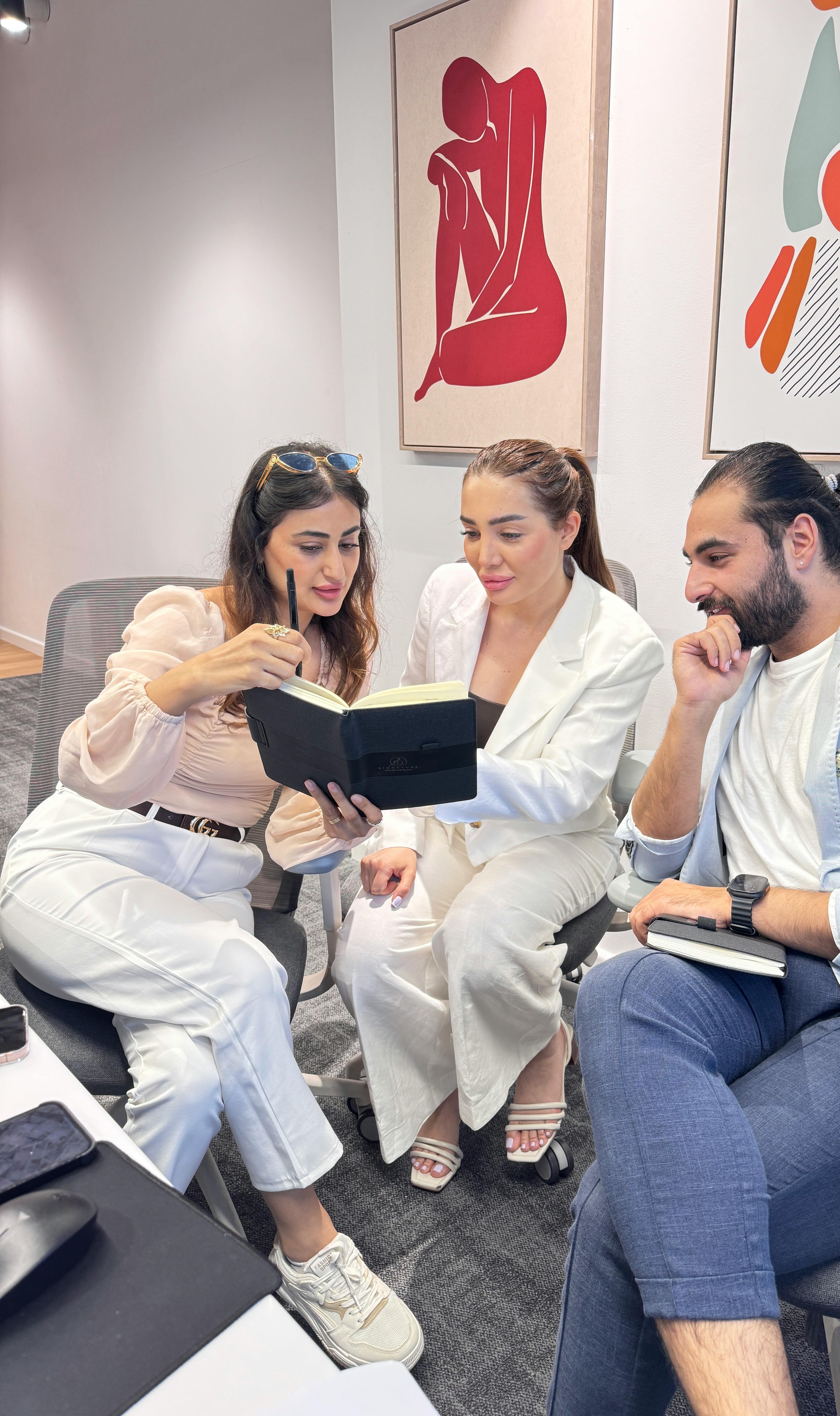 A small business team collaborates on a new marketing project in a bright office.