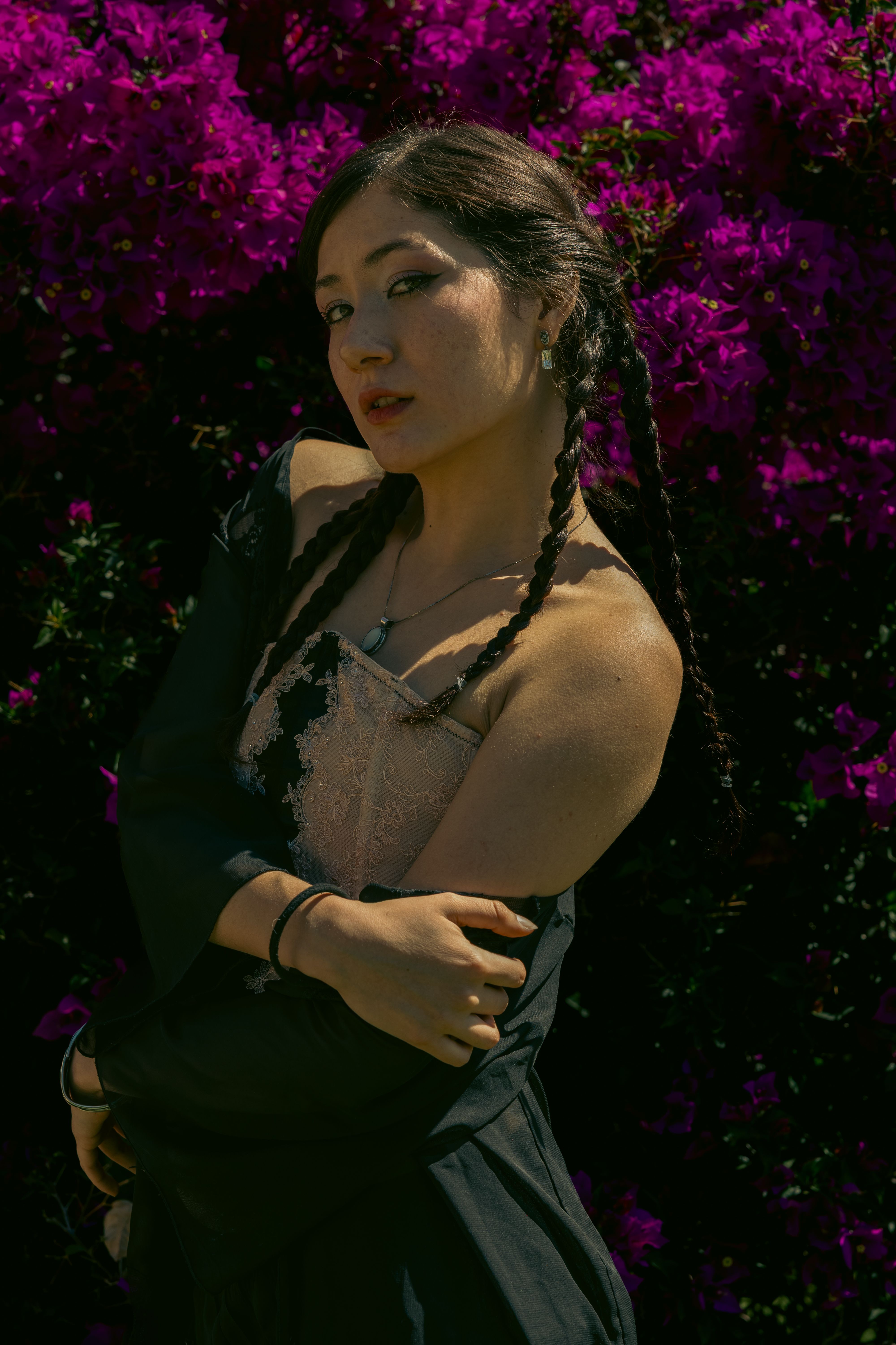 Woman in Floral Dress Posing Outdoors · Free Stock Photo