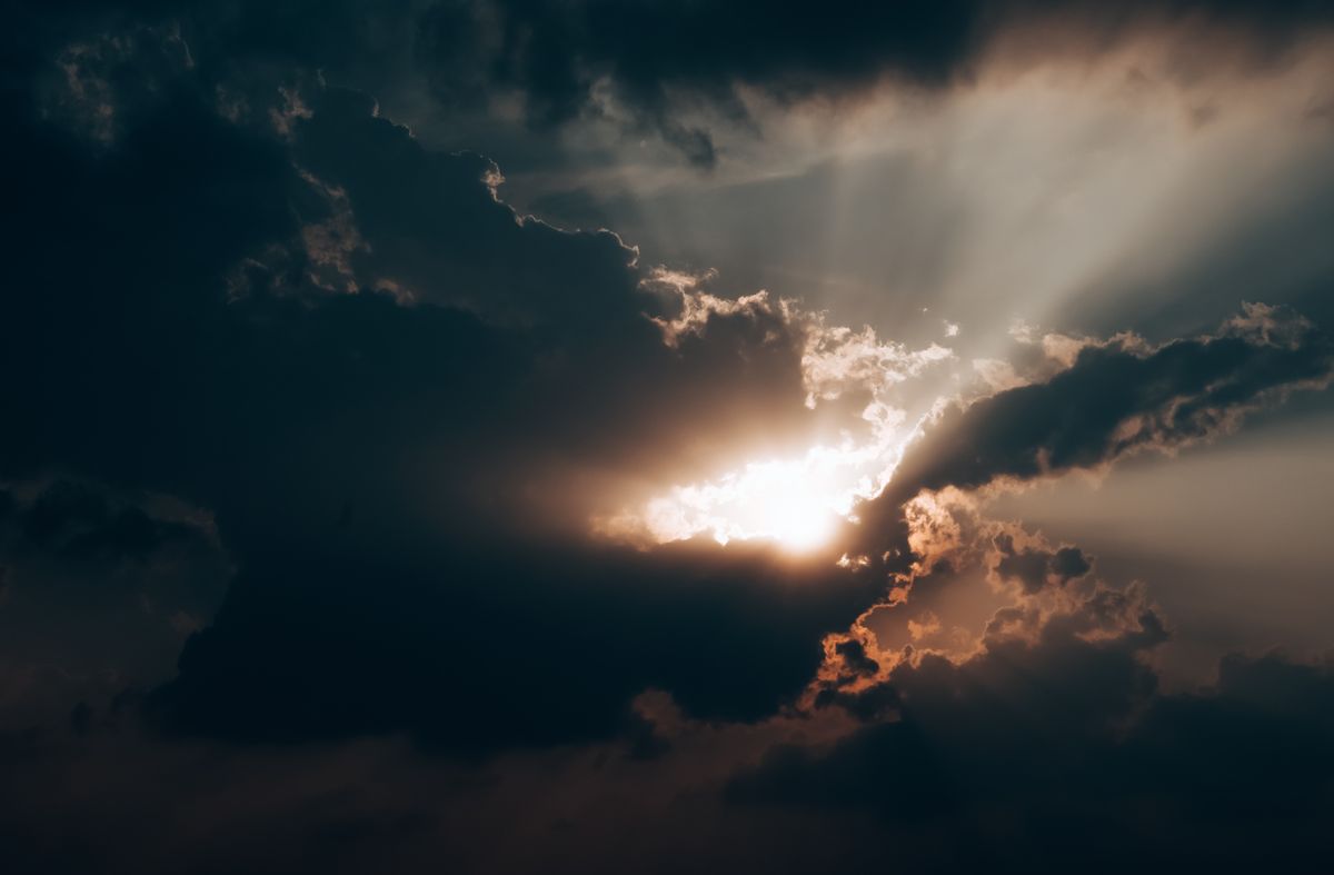 Sunlight breaking dramatically through dark clouds representing the telehealth affiliate opportunity most marketers are missing