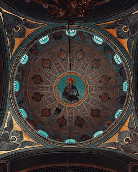 Stunning ornamental church ceiling featuring detailed religious artwork and intricate patterns.
