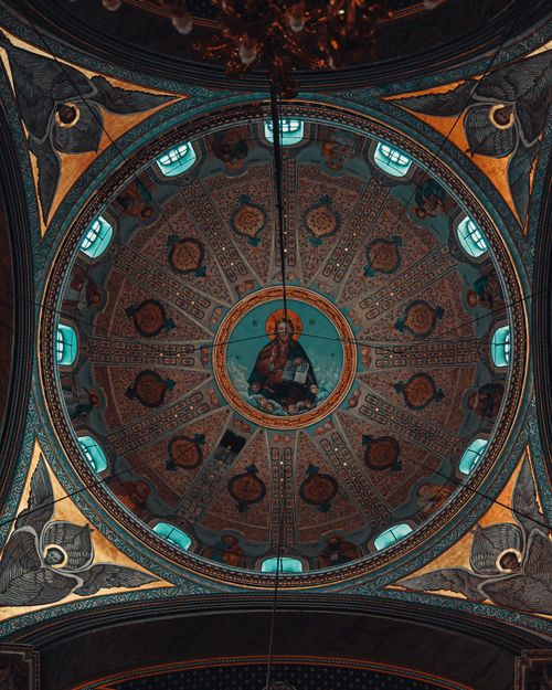 Free Stunning ornamental church ceiling featuring detailed religious artwork and intricate patterns. Stock Photo