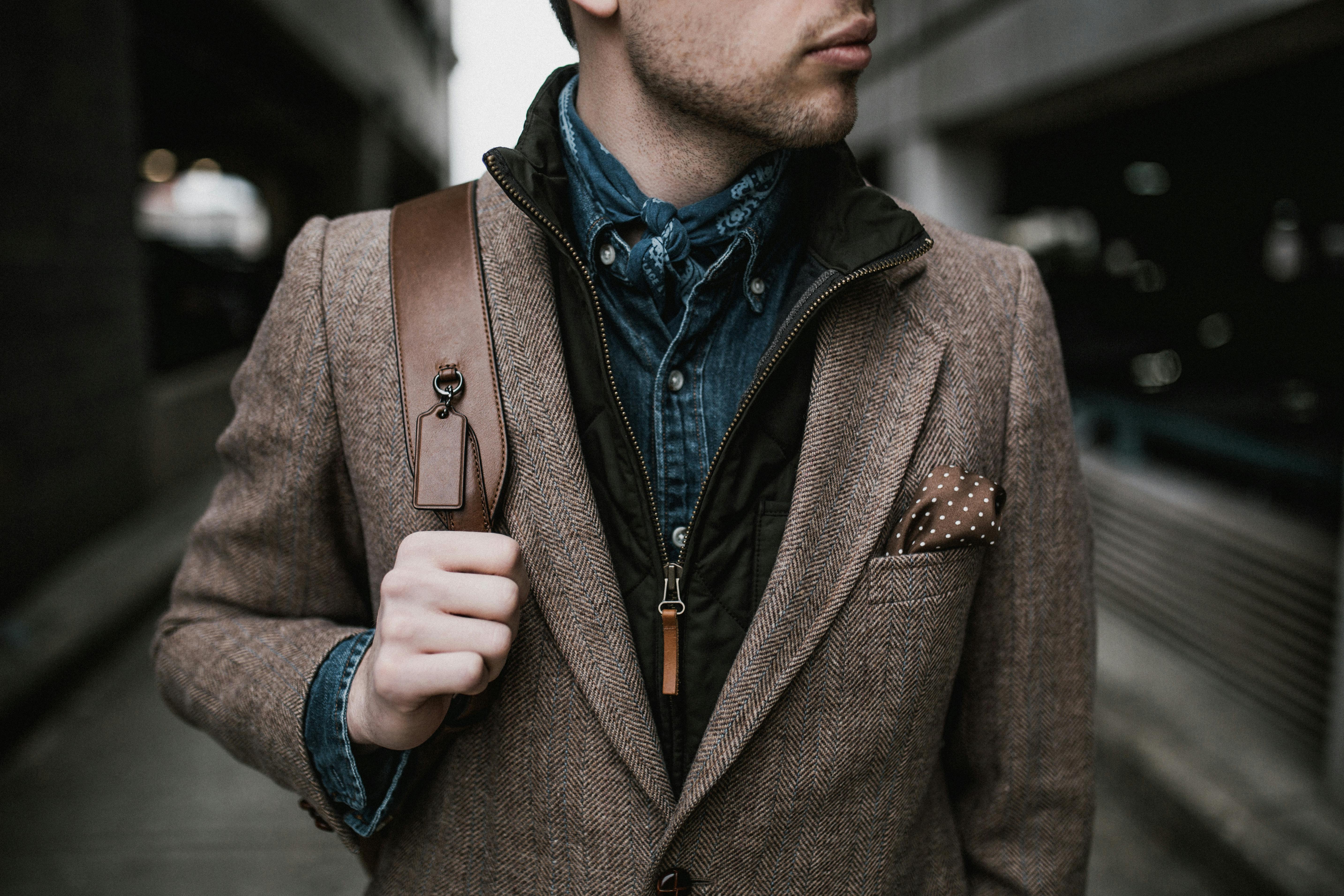 photo of man wearing brown coat