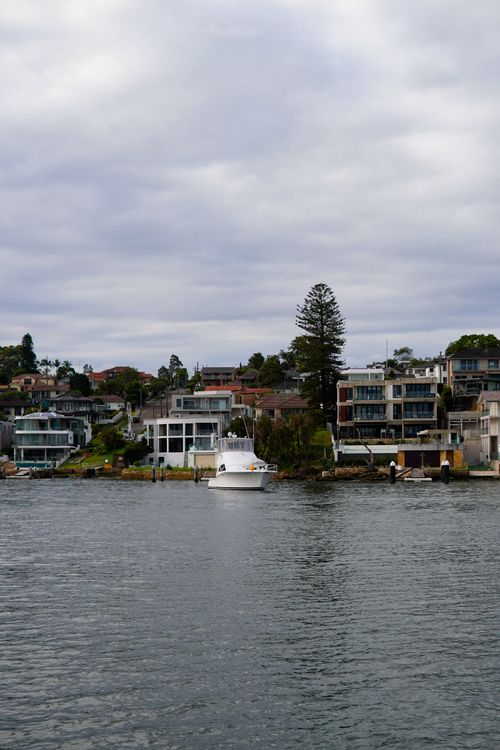 Free Modern architecture by the waterfront with a serene sea view under cloudy skies. Stock Photo