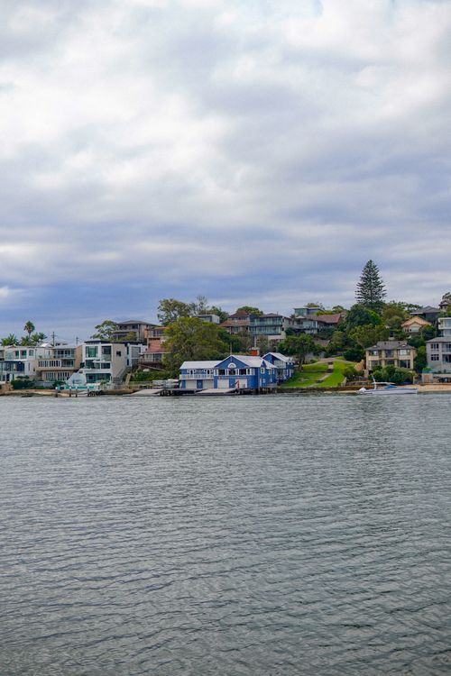 Free Picturesque seaside houses on a cloudy day by the waterfront, showcasing serene architecture. Stock Photo