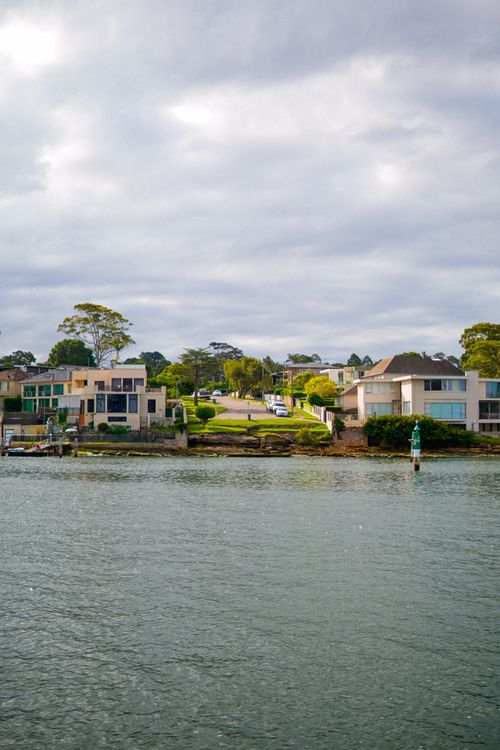 Free A peaceful scene of modern architecture by the seaside under a cloudy sky. Stock Photo