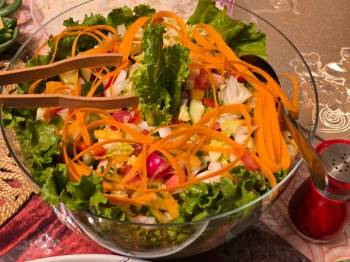 Free A vibrant vegetable salad with carrots, cucumbers, and lettuce in a glass bowl. Stock Photo