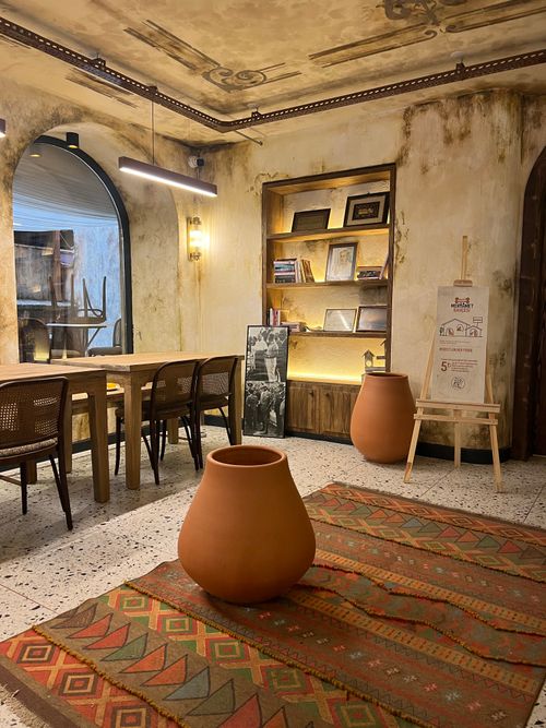 Free Warm, inviting cafe interior with rustic pottery and vintage decor. Stock Photo