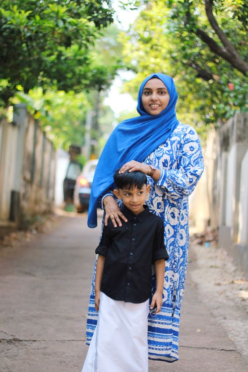 Free Portrait of a mother and son in Kerala traditional dress outdoors, showcasing cultural attire. Stock Photo