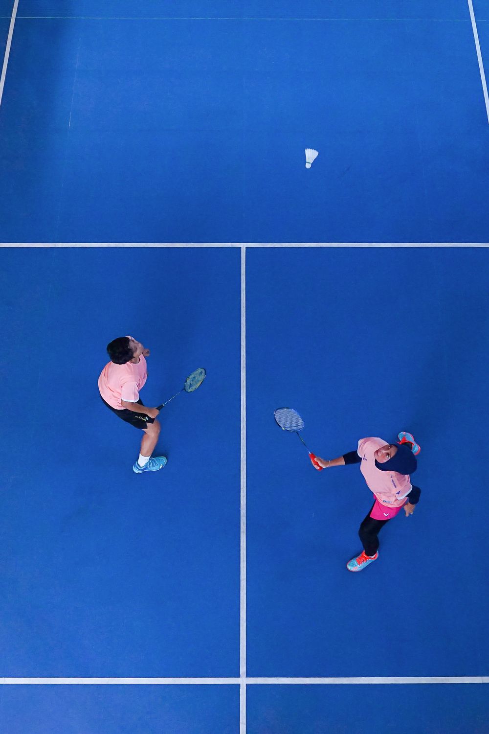 Aerial view of a blue badminton court