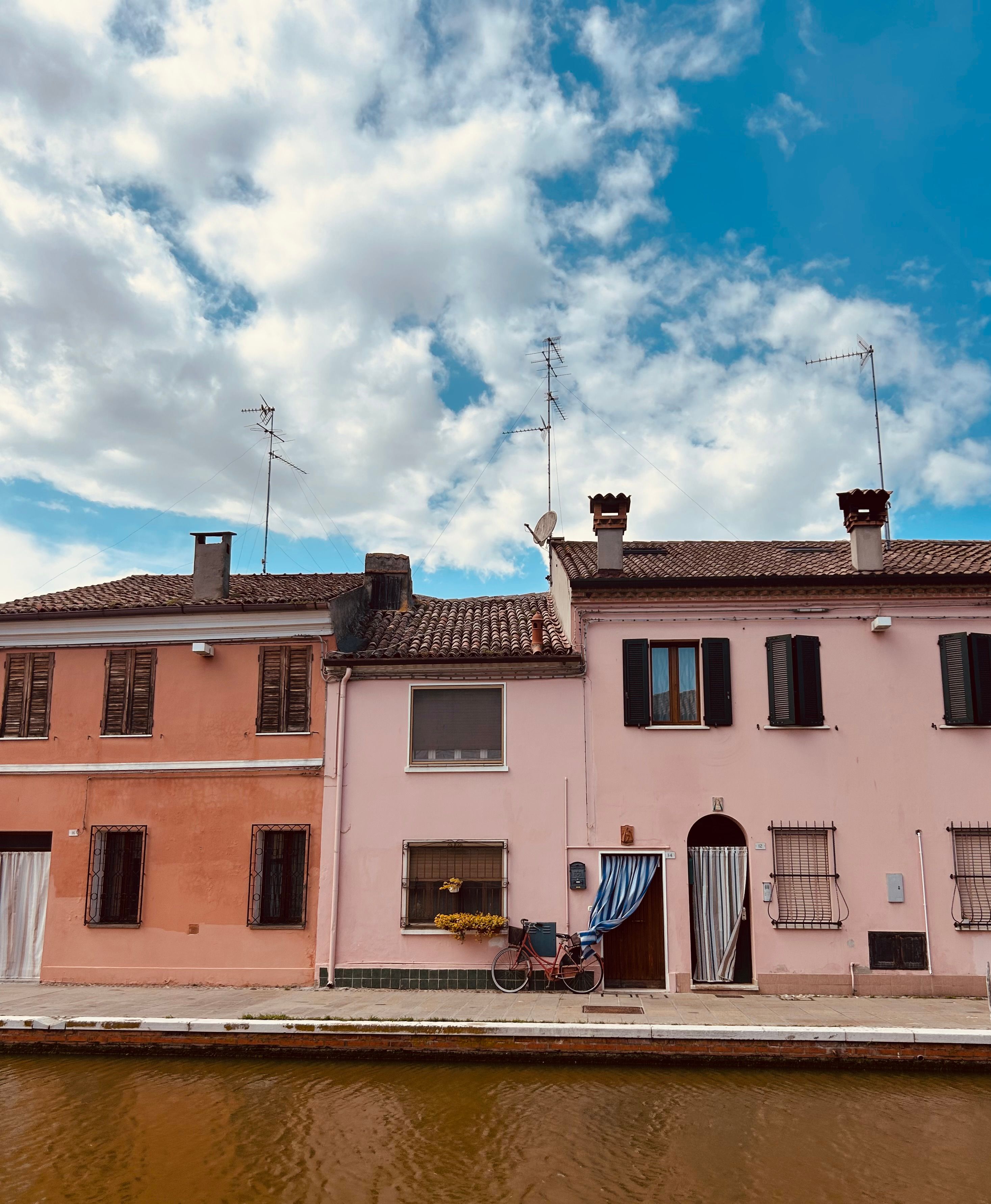 Charming Canal Houses Under a Bright Blue Sky · Free Stock Photo
