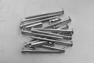 Metal Screws and Bolts on a White Surface