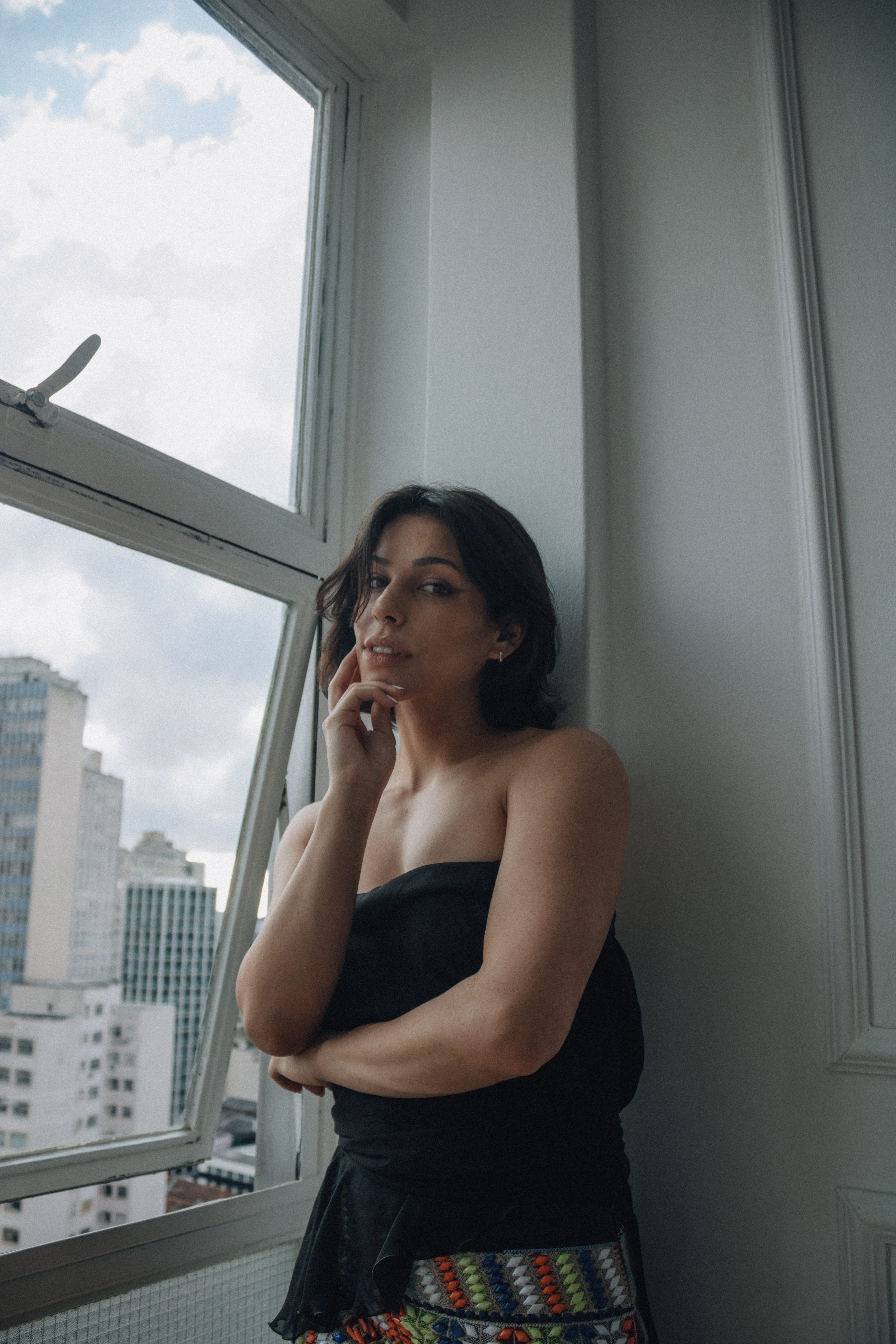 Contemplative Woman by Urban Window View · Free Stock Photo
