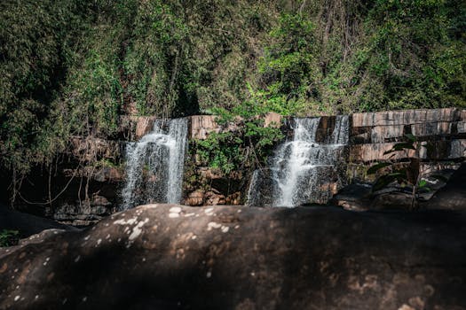 Captivating waterfall amidst lush greenery in a Thai jungle, perfect nature escape.