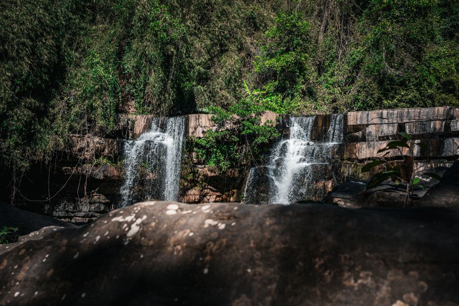 Captivating waterfall amidst lush greenery in a Thai jungle, perfect nature escape.