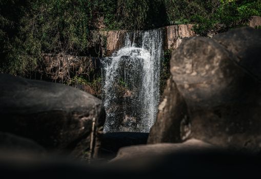 A serene waterfall nestled in the lush forests of Thailand, surrounded by nature.