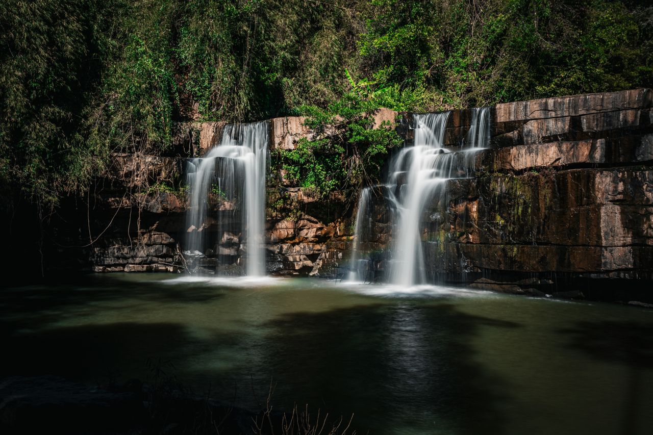 breathtaking view of a waterfall cascading in a lush forest in thailan