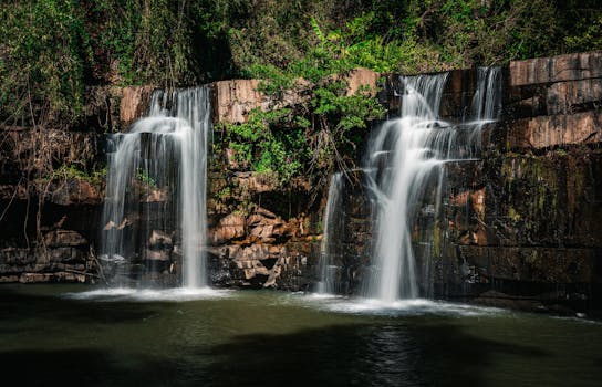 A stunning cascading waterfall surrounded by lush greenery in Thailand's serene forest.