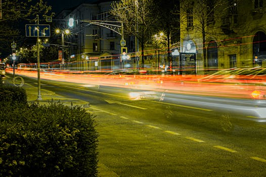 Dynamic long exposure capturing vibrant city street lights at night, showcasing urban energy and movement.
