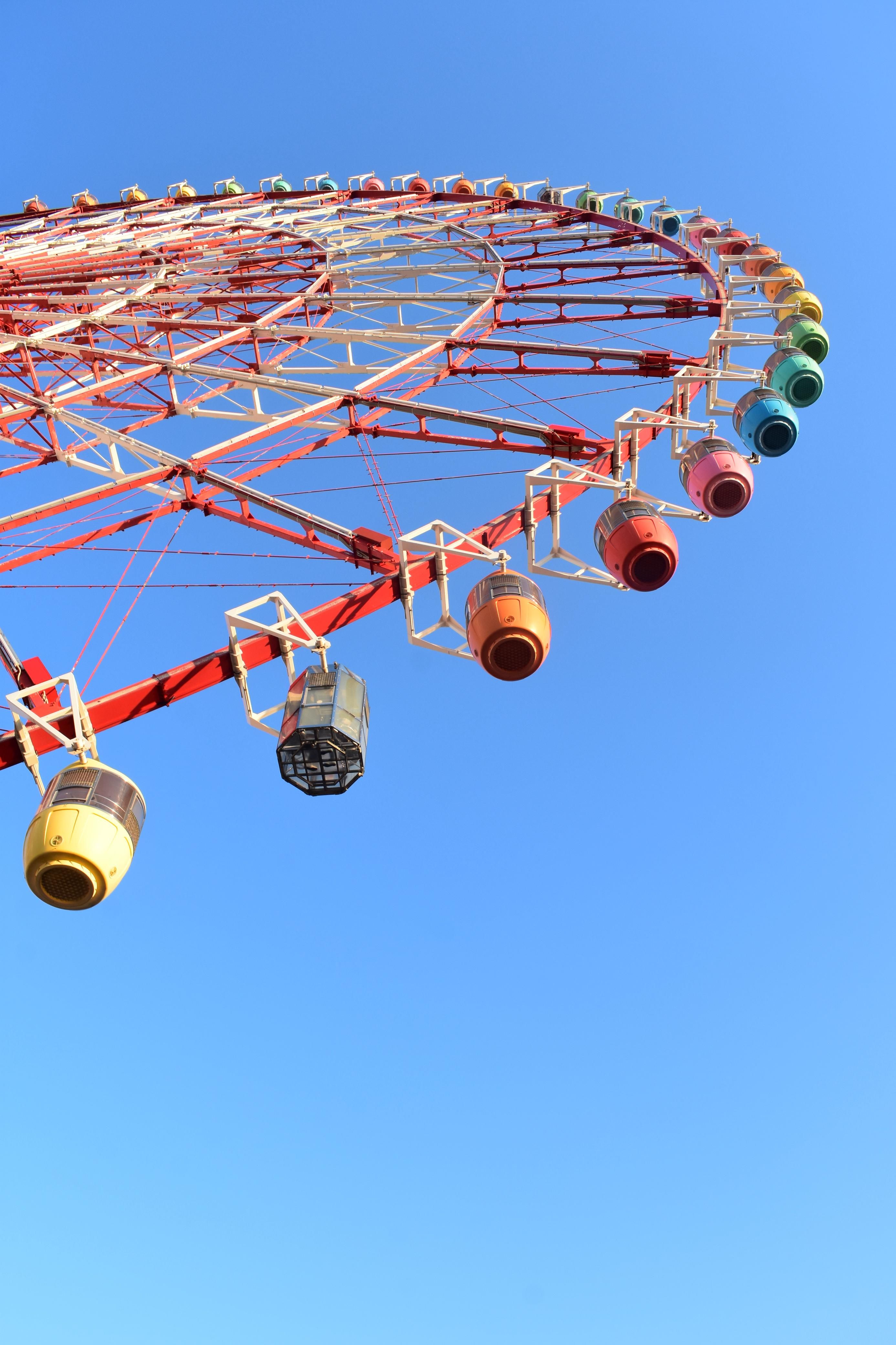 Brightly colored Ferris wheel cabins set against a clear blue sky in Kōtō, Tokyo.